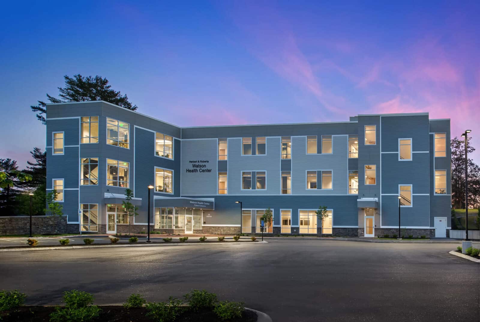 Watson health center at dusk with the lights on