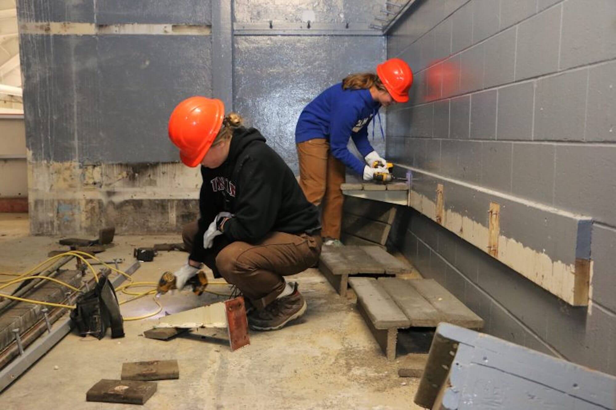 Students doing demolition work on the Travis Roy Ice Arena