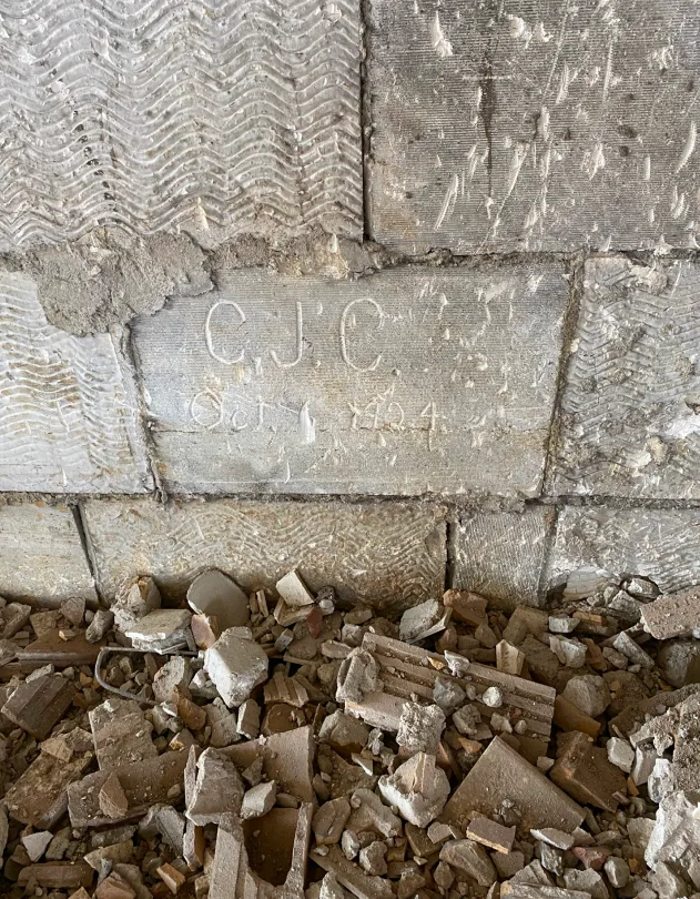 Image of initials written in stone in preconstruction